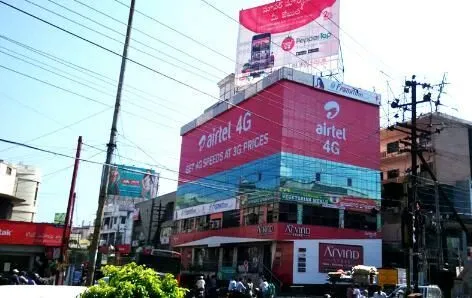Multi-storey building wrapped in telecom brand advertising