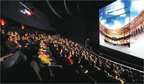 Cinema audience watching a brand advertisement on screen