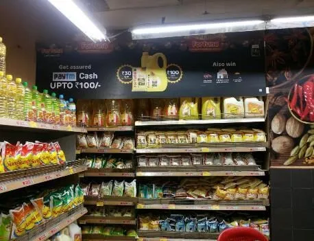 In-store aisle branding above a supermarket shelf