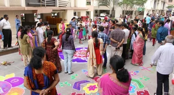 Residents taking part in a branded rangoli contest inside an apartment complex