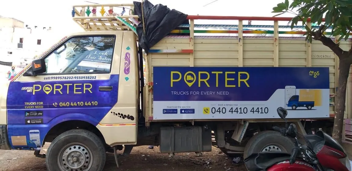 Commercial mini truck wrapped in logistics brand livery
